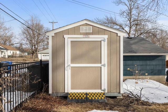 view of shed featuring fence