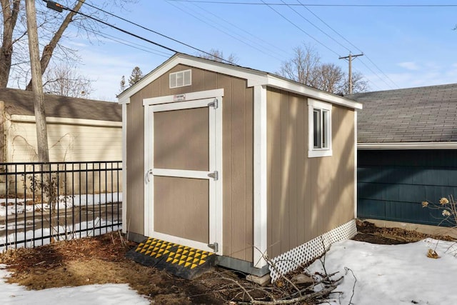 view of shed with fence