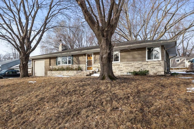 ranch-style home featuring an attached garage, stone siding, and a chimney