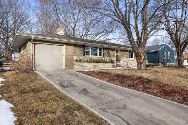 ranch-style home with an attached garage, stone siding, driveway, and a chimney