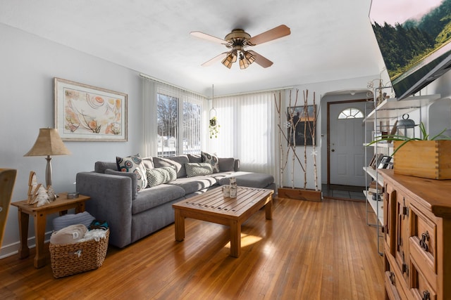 living room with hardwood / wood-style flooring and ceiling fan