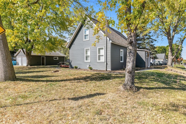 view of side of home with a yard