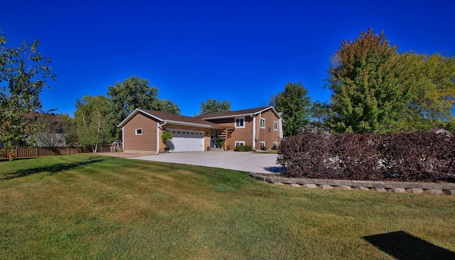 view of front of home featuring a front yard and a garage