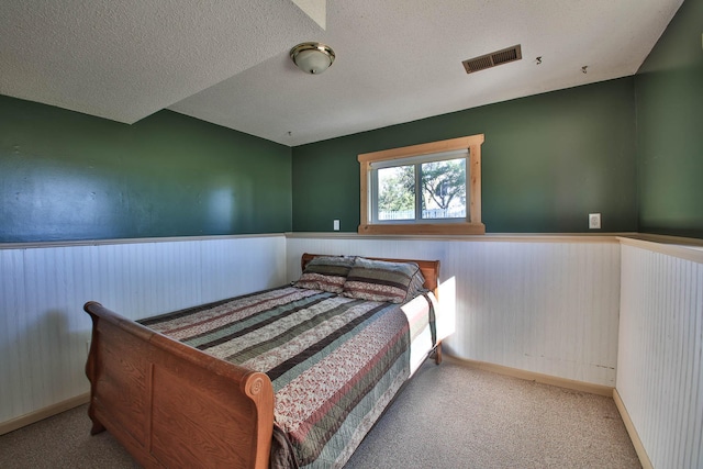 carpeted bedroom featuring a textured ceiling