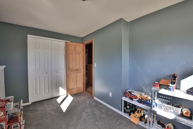 playroom featuring dark colored carpet