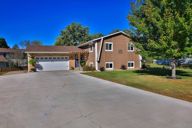 split level home with a front yard and a garage