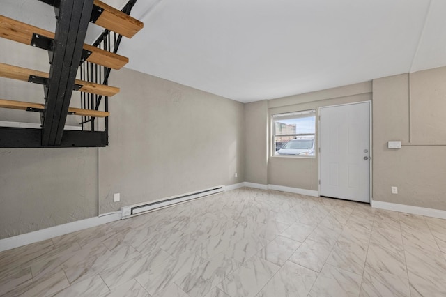 unfurnished living room featuring a baseboard heating unit