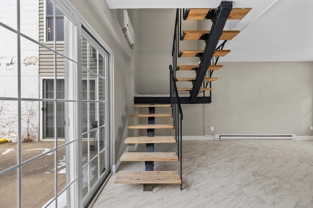 stairway featuring a wealth of natural light and baseboard heating