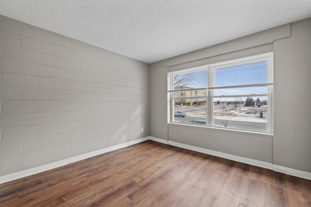 unfurnished room with dark hardwood / wood-style flooring