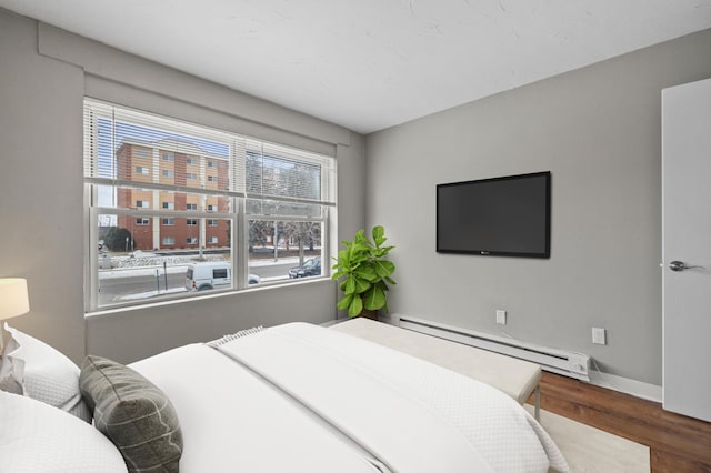 bedroom featuring a baseboard radiator and dark hardwood / wood-style flooring