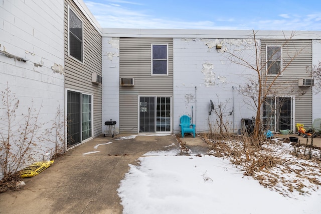 view of snow covered rear of property