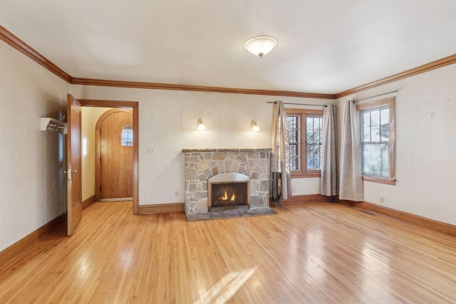 unfurnished living room with a fireplace, light wood-type flooring, and crown molding