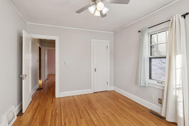 unfurnished bedroom with light hardwood / wood-style floors, ceiling fan, and ornamental molding