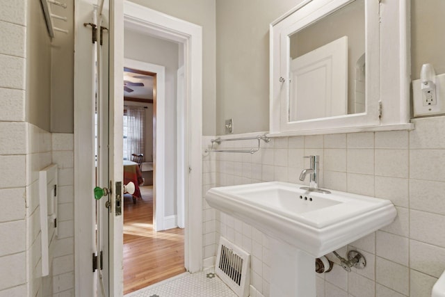 bathroom with tile patterned flooring and tile walls