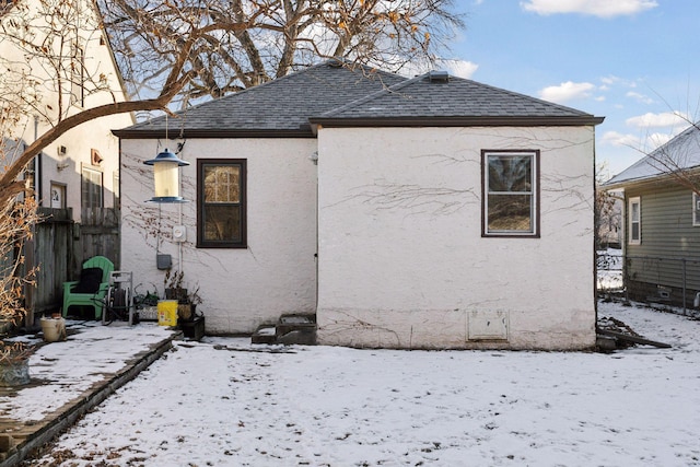 view of snow covered rear of property