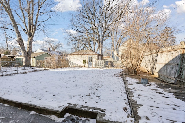 yard layered in snow featuring an outdoor structure