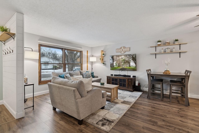 living room featuring dark hardwood / wood-style floors and a textured ceiling