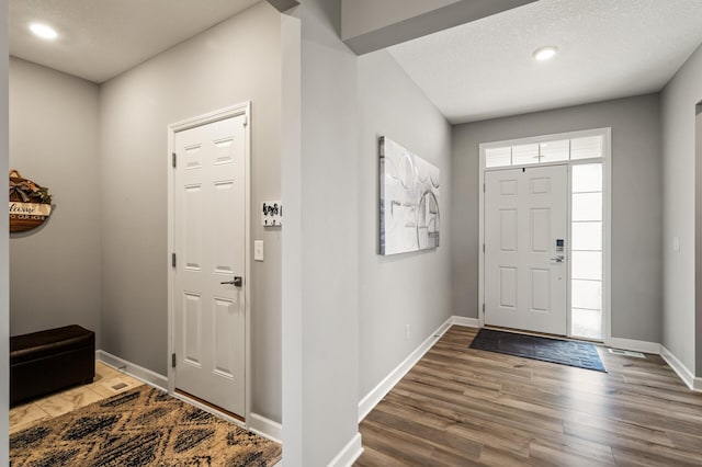 foyer featuring hardwood / wood-style floors and a textured ceiling