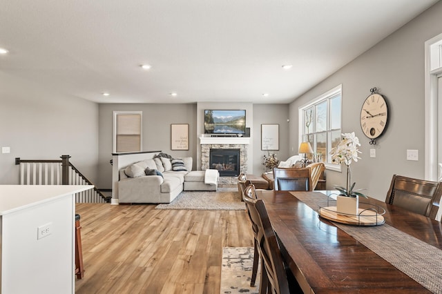 dining area with a fireplace and light hardwood / wood-style flooring