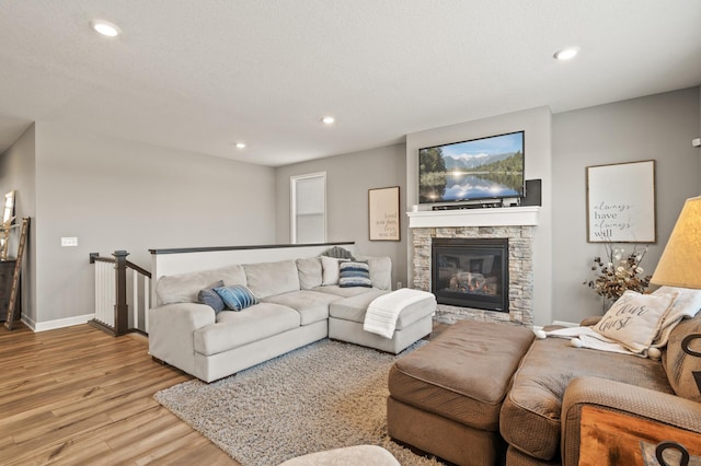 living room featuring a fireplace and light wood-type flooring