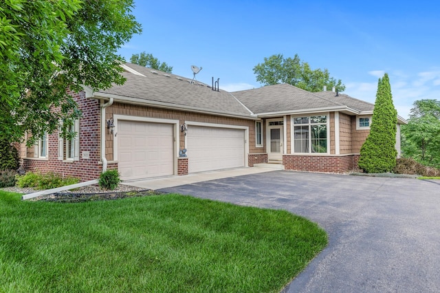 single story home with a garage and a front lawn