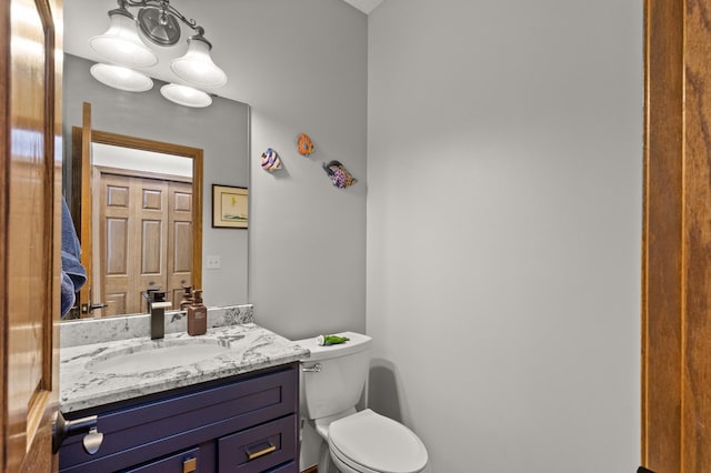 bathroom with toilet and vanity