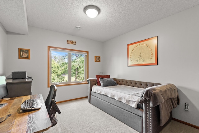 bedroom with a textured ceiling and light carpet