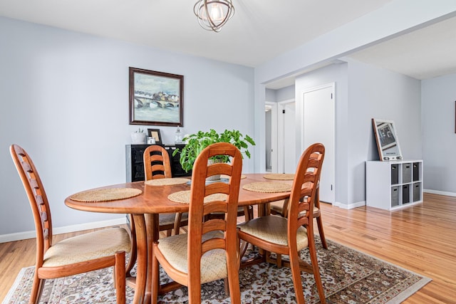 dining room with light wood-style flooring and baseboards