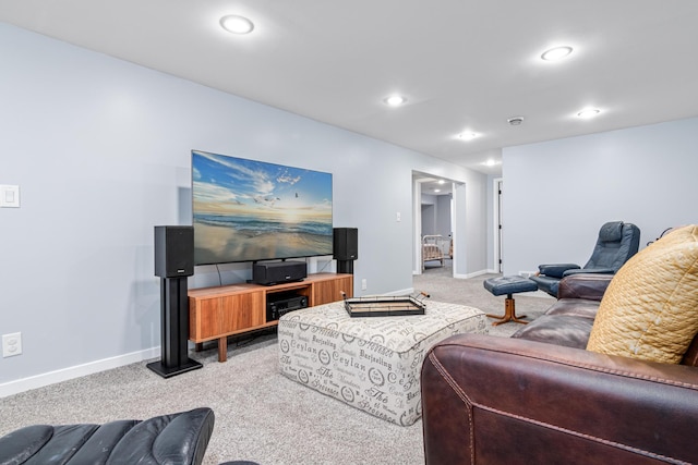 carpeted living area featuring baseboards and recessed lighting