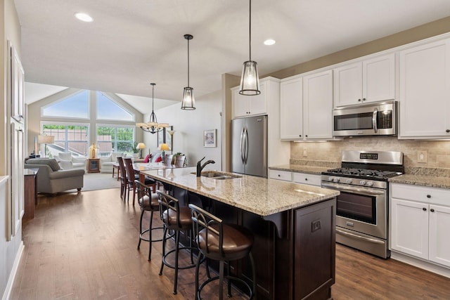 8160 Virginia Ln, Savage, MN 55378 - kitchen featuring stainless steel appliances, dark wood-style flooring, open floor plan, white cabinets, and vaulted ceiling