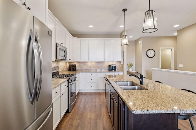 8160 Virginia Ln, Savage, MN 55378 - kitchen with appliances with stainless steel finishes, dark wood finished floors, recessed lighting, white cabinets, and backsplash