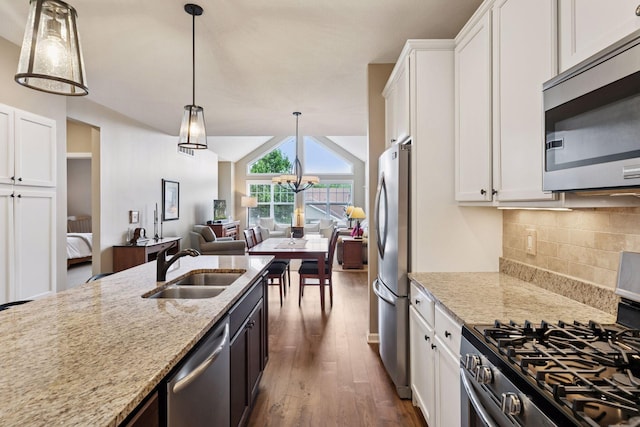 8160 Virginia Ln, Savage, MN 55378 - kitchen with appliances with stainless steel finishes, dark wood finished floors, white cabinetry, decorative backsplash, and light stone counters