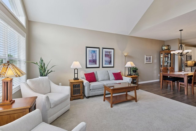 8160 Virginia Ln, Savage, MN 55378 - carpeted living area with vaulted ceiling, a chandelier, and wood finished floors