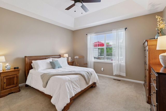 8160 Virginia Ln, Savage, MN 55378 - bedroom with light carpet, a tray ceiling, and a ceiling fan