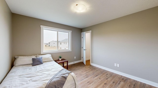 bedroom with light hardwood / wood-style flooring