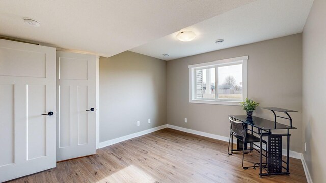 office area with light hardwood / wood-style flooring