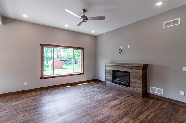 unfurnished living room with ceiling fan and dark wood-type flooring