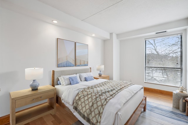 bedroom with wood-type flooring