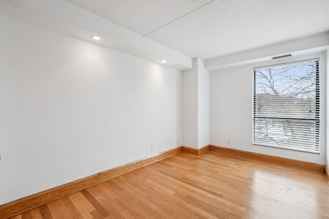 empty room with hardwood / wood-style flooring