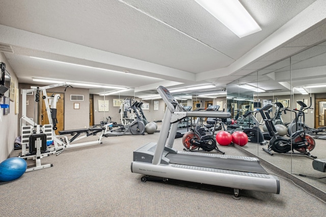 gym featuring a textured ceiling