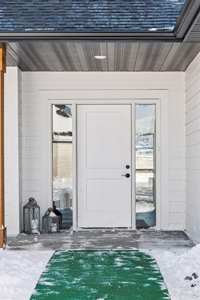 property entrance with a shingled roof