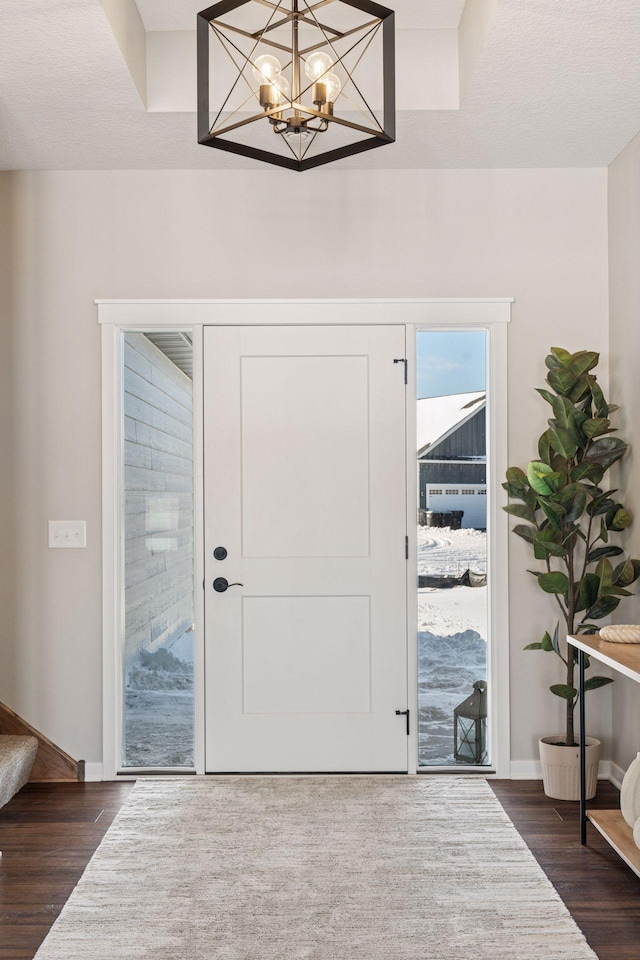 entryway featuring stairs, baseboards, and dark wood-style flooring