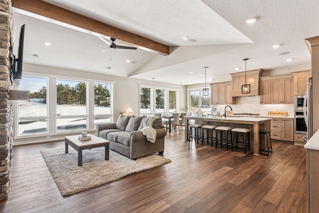 living area featuring dark wood-style floors, recessed lighting, lofted ceiling with beams, a ceiling fan, and a textured ceiling