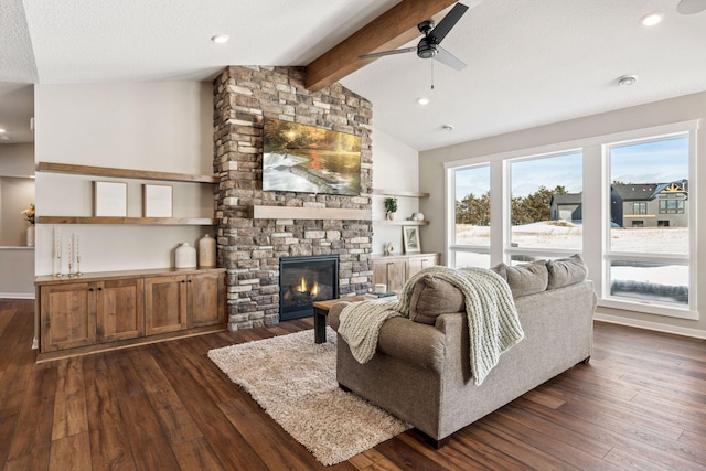 living area with a fireplace, dark wood finished floors, lofted ceiling with beams, and ceiling fan