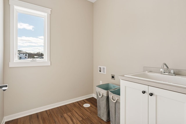 laundry room featuring cabinet space, baseboards, dark wood-style flooring, hookup for an electric dryer, and a sink