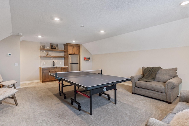 rec room with baseboards, light colored carpet, lofted ceiling, a textured ceiling, and recessed lighting