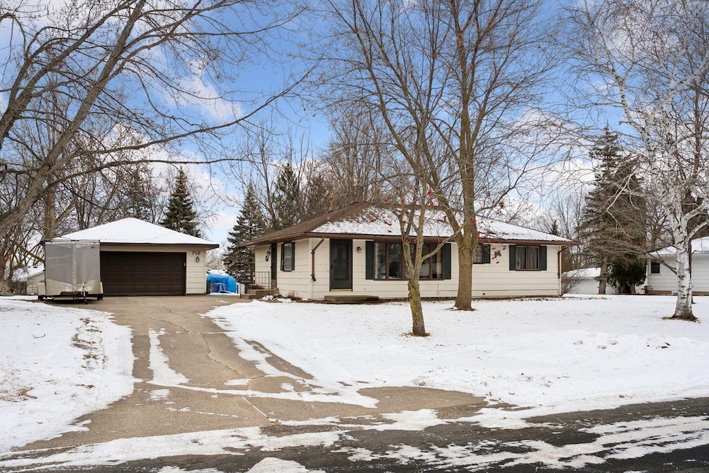 ranch-style house featuring a detached garage