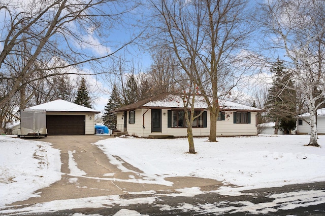 ranch-style house featuring a detached garage