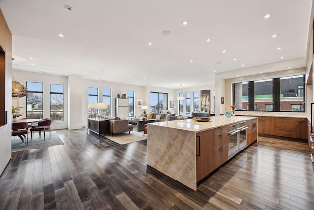 kitchen with dark hardwood / wood-style floors, oven, and a kitchen island