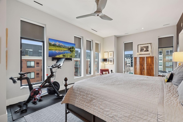 bedroom featuring multiple windows and ceiling fan